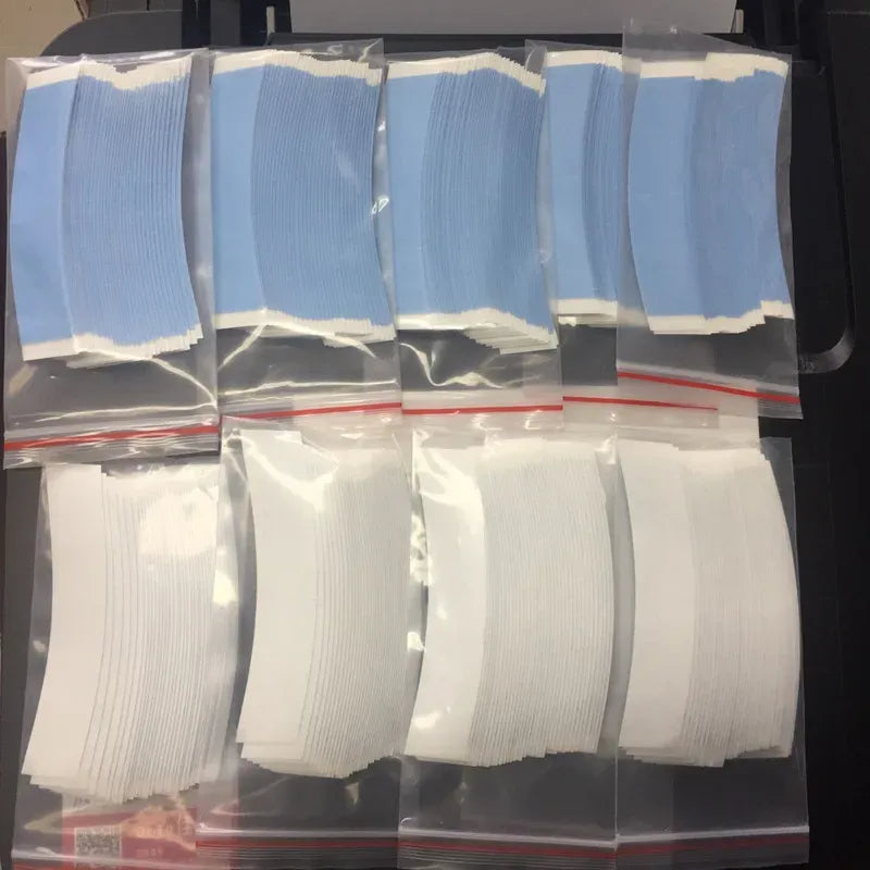 White and light blue adhesive tape strips in clear bags, assorted pieces