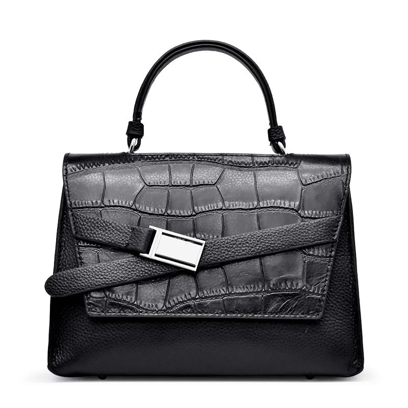 Black genuine leather designer handbag with crocodile texture, top handle, and silver buckle strap detail.