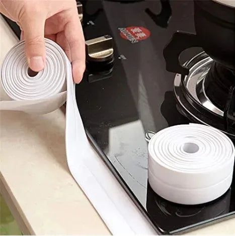 White waterproof sealing tape roll with adhesive strip, applied along countertop edge