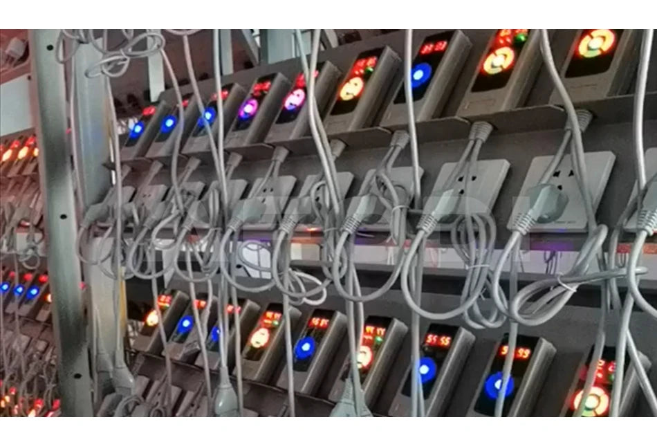 Rows of gray, rectangular digital power timers plugged into wall outlets, used for automated device management.
