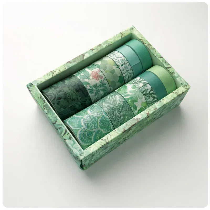 Green decorative washi tape rolls set in a boxed tray, leaf and floral patterns