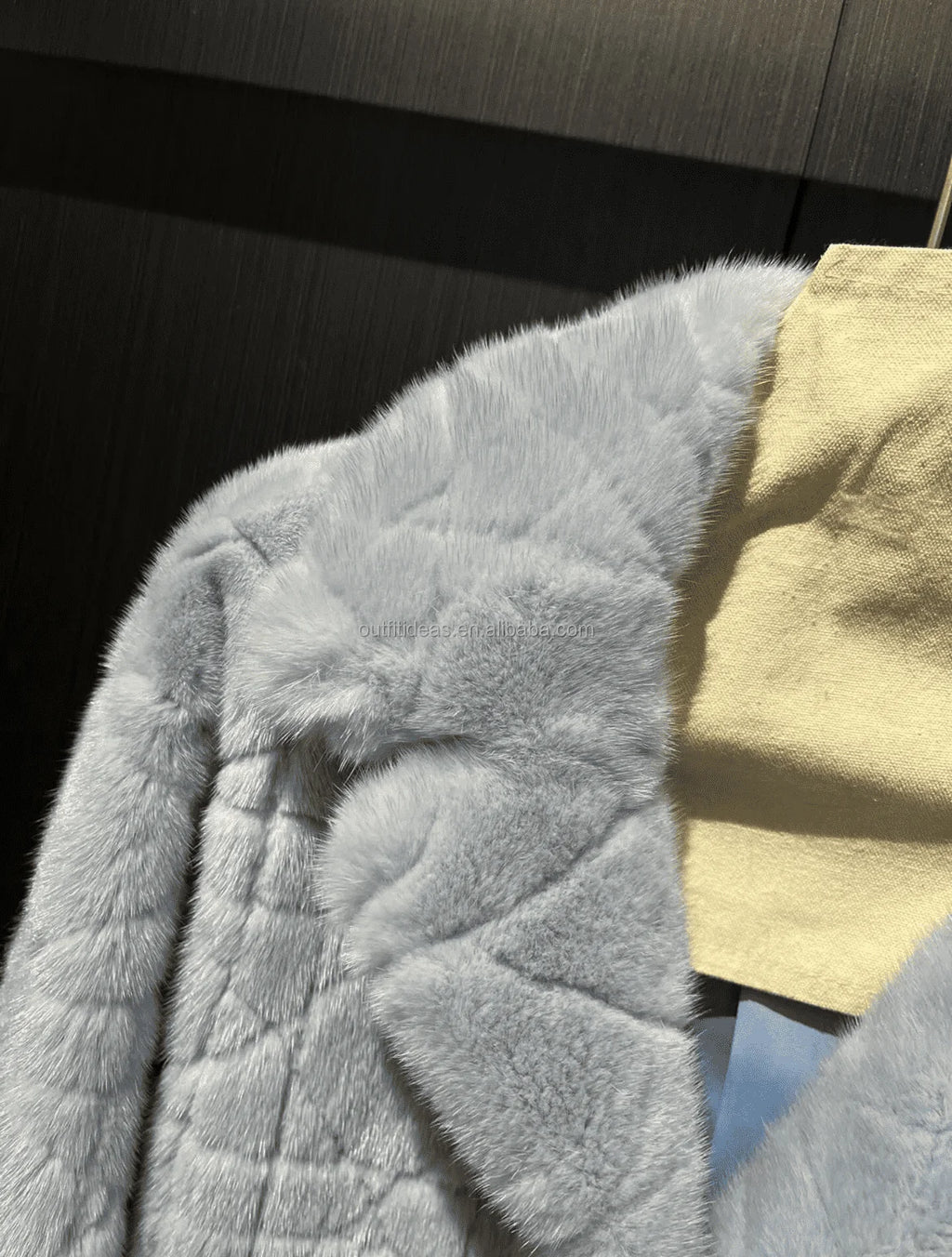 Luxury grey mink fur scarf with quilted geometric pattern texture and soft pastel blue tone.