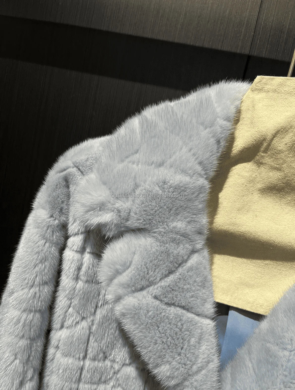 Luxury grey mink fur scarf with quilted geometric pattern texture and soft pastel blue tone.