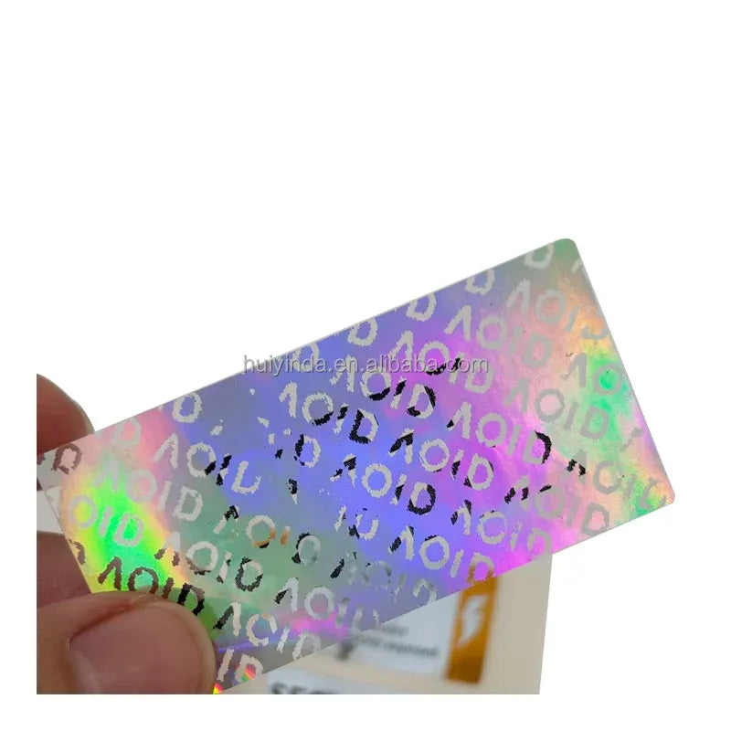 Holographic void security label held in hand, prismatic VOID text