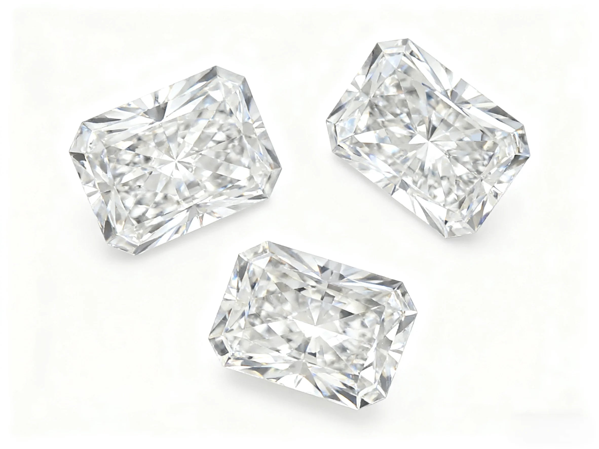Three lab-grown radiant-cut diamonds arranged for viewing
