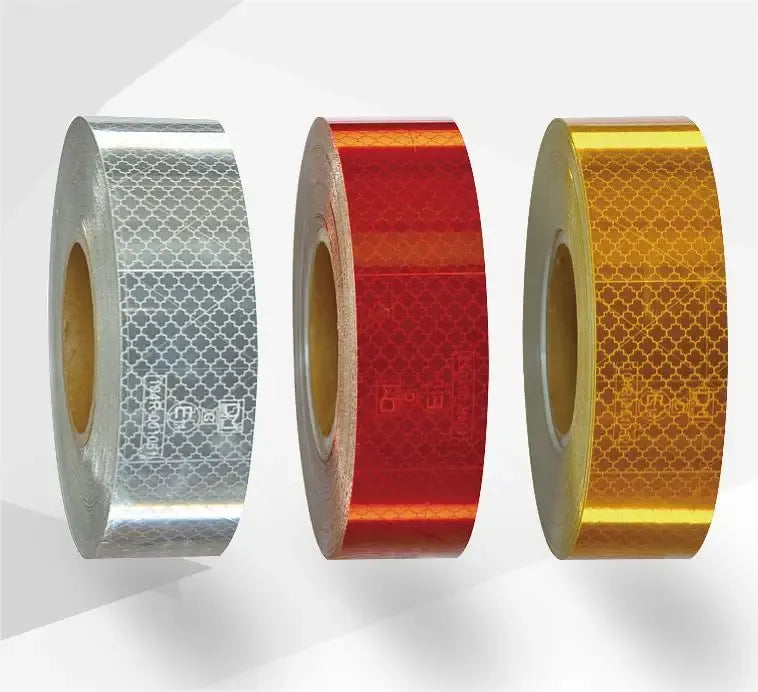 Reflective road safety tape roll, silver white patterned strip on a core
