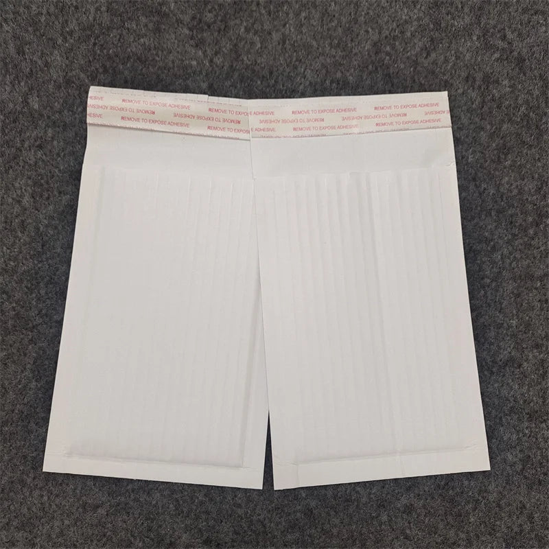 White padded shipping mailer bag with printed header and red label text