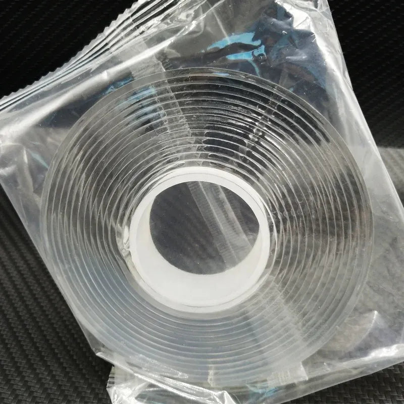 White double-sided nano tape roll in plastic bag, concentric coil ridges visible