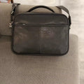 Vintage black cowhide leather horizontal messenger bag with top handle and crossbody strap for business daily carry.