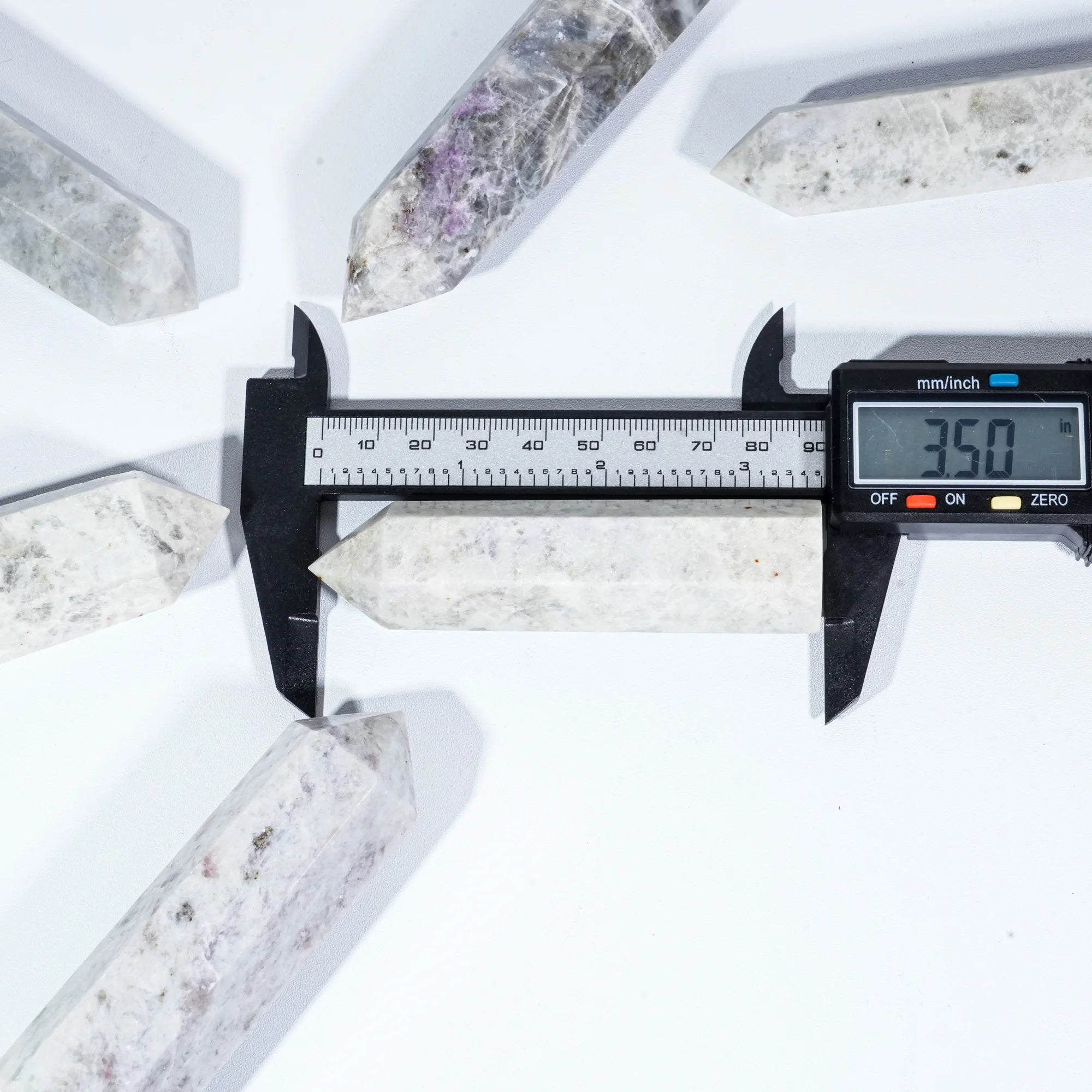 Purple sodalite crystal point tower measured with a digital caliper
