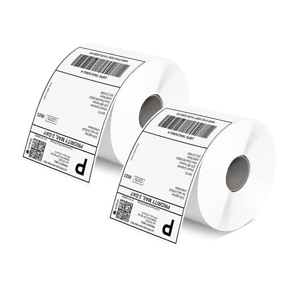 Two white label rolls with barcodes and address text labels, angled view