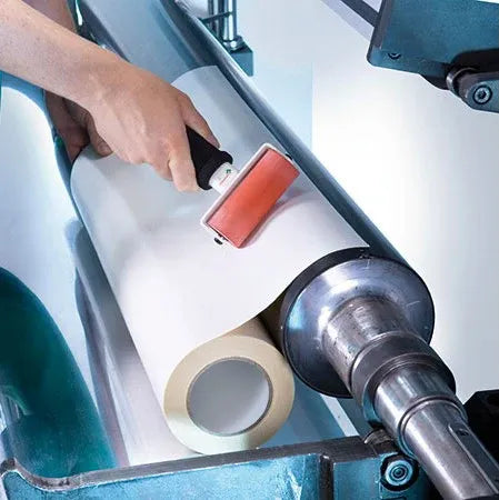 Double-sided mounting tape being applied to printing press bed