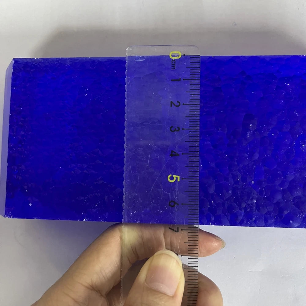 Blue synthetic hydrothermal crystal block with ruler showing height markings.