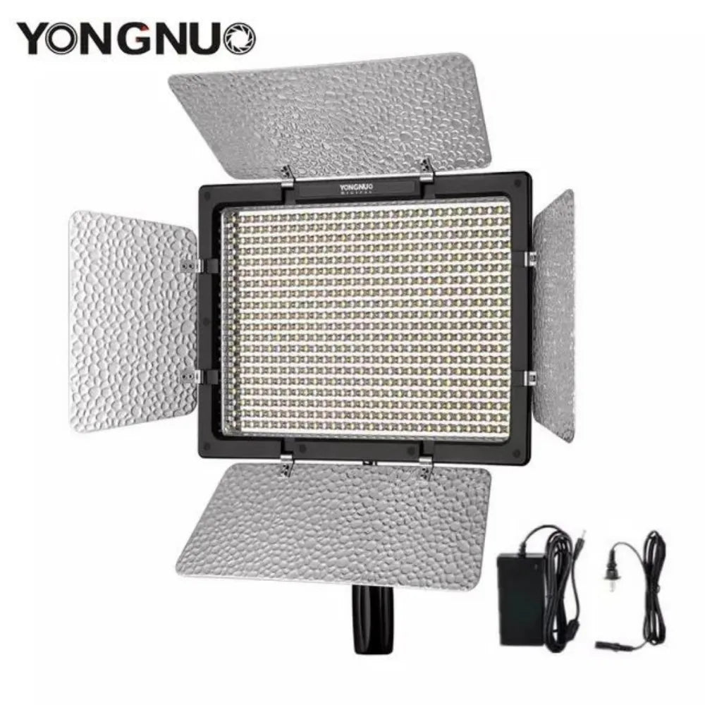 Rectangular LED video light panel with four silver textured barn doors and an included power adapter.