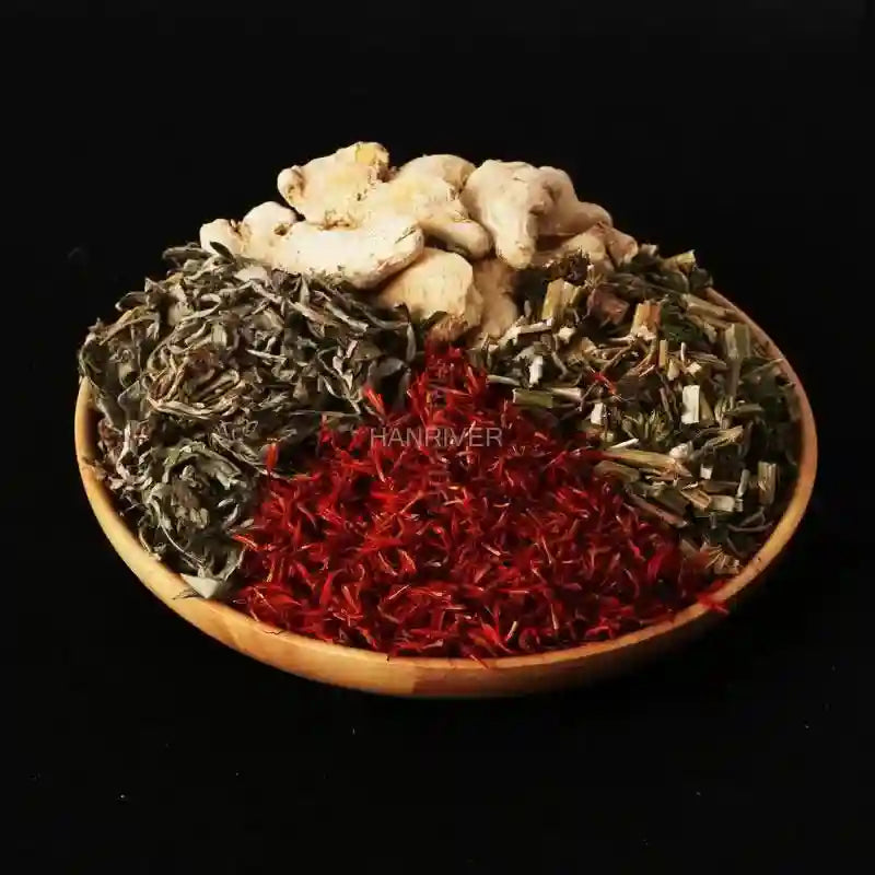 Chinese medicine herbal foot soak ingredients with ginger, safflower, and wormwood in a wooden bowl for spa therapy.