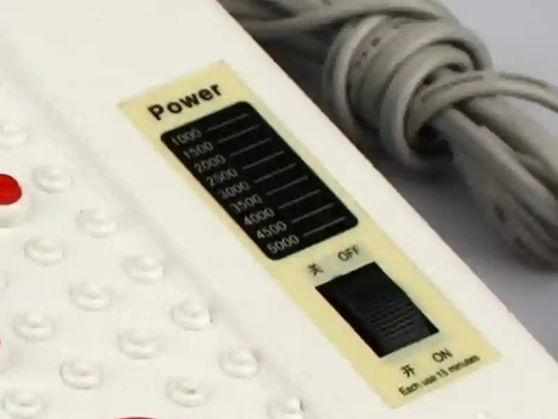 White electric vibrating foot massager with infrared heat, power level settings, and reflexology acupressure nodes.