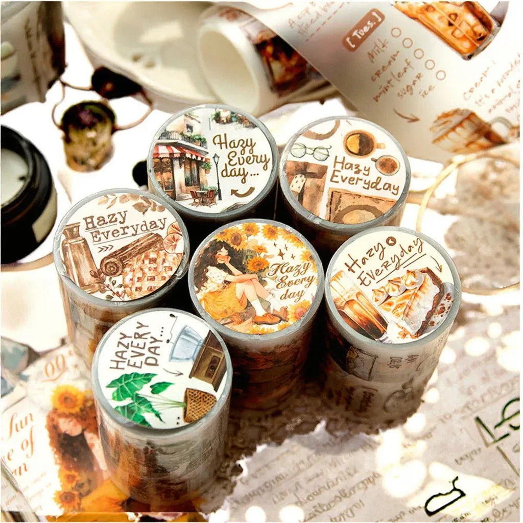 Close view of multiple matte PET tape rolls with “Hazy Everyday” themed graphics.