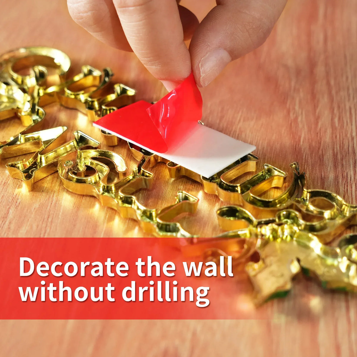 Red double-sided foam tape holding a white backing and gold hardware pieces