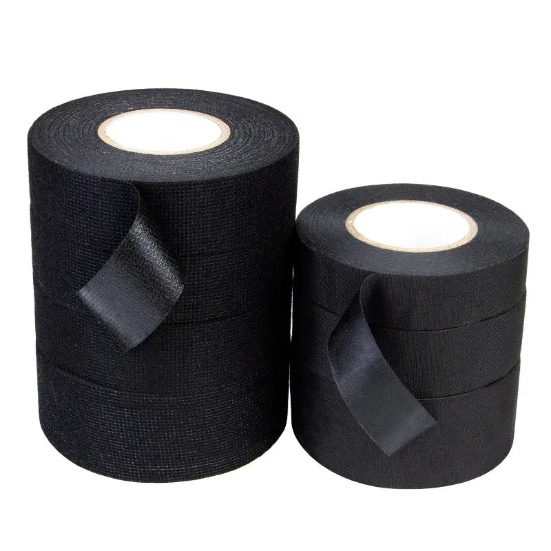 Black fabric insulation tape rolls with cut strip ends and inner paper cores visible