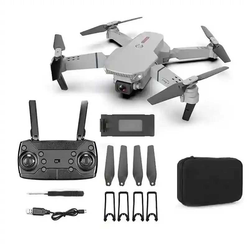 Grey foldable camera drone with remote controller, battery, spare propellers, guards, charging cable, and carry case.