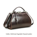 Coffee brown full-grain leather doctor satchel bag with vintage brass lock and detachable crossbody strap.