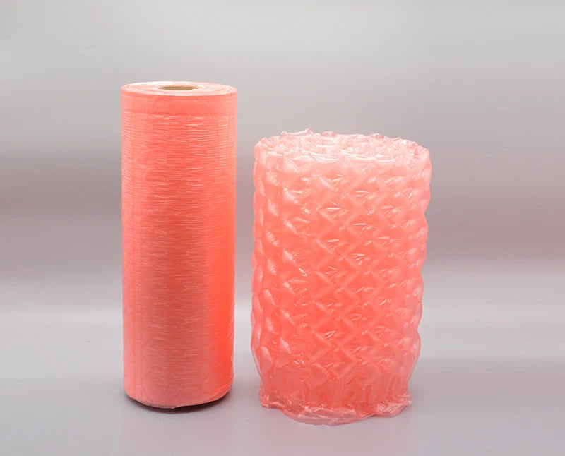 Pink bubble wrap roll and small wrapped cylinder with air-cushion pattern