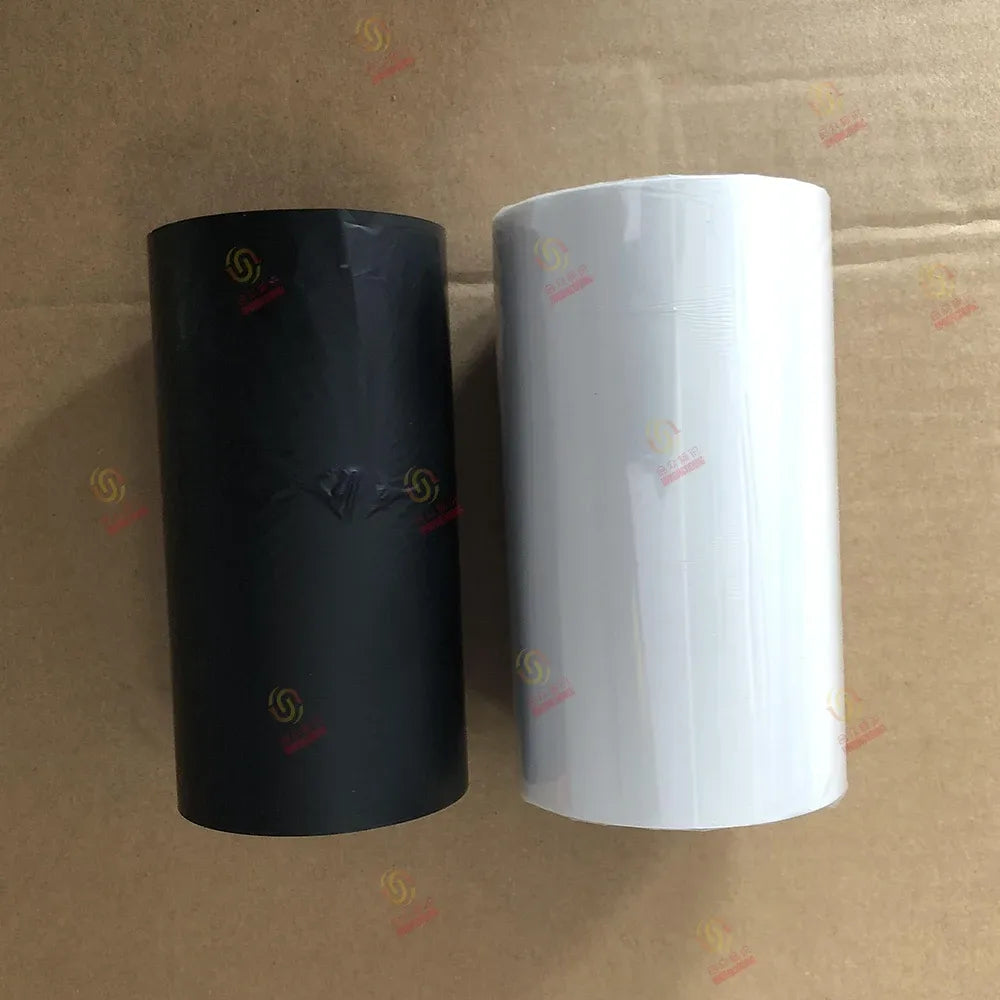 Black and white thermal barcode ribbon rolls on cardboard cores