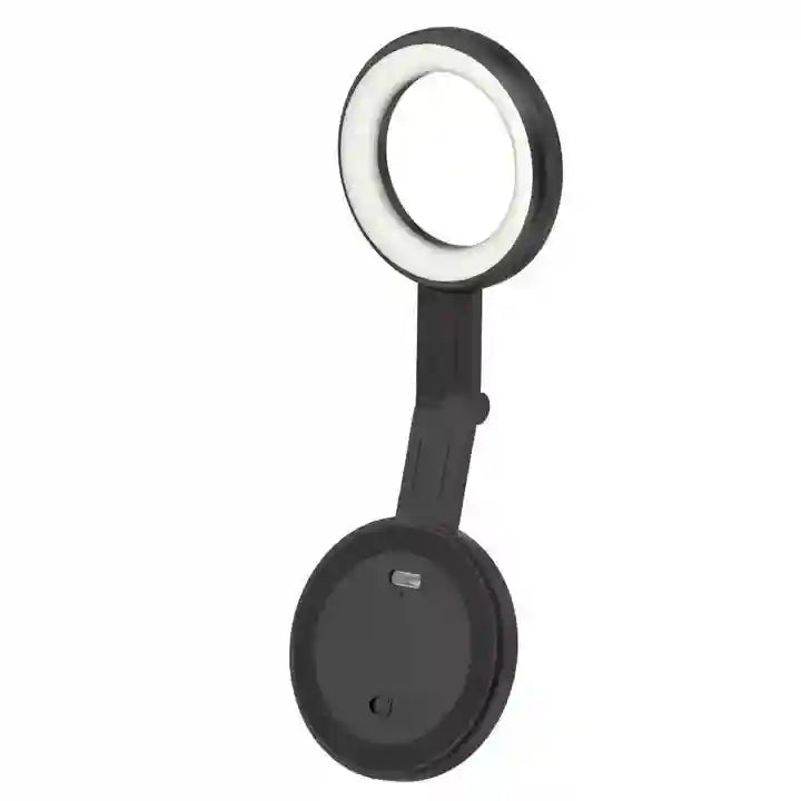 Portable black LED ring light with folding arm and circular magnetic base for phone attachment.