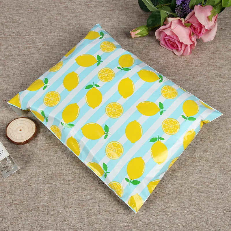 Light blue plastic mailing bag with yellow lemon and leaf pattern