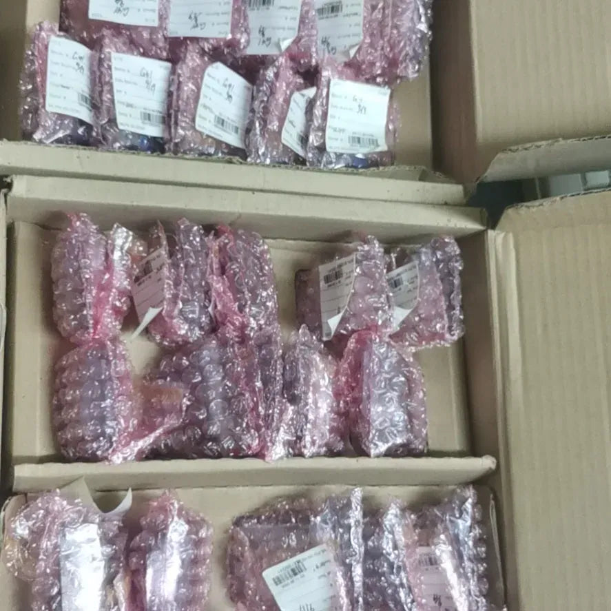 Pack of multiple barcode scanner modules in protective pink bags inside shipping box
