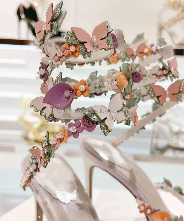 Luxury bridal stiletto heels with leather butterfly and floral embellishments, crystal accents, and wrap-around ankle ties.