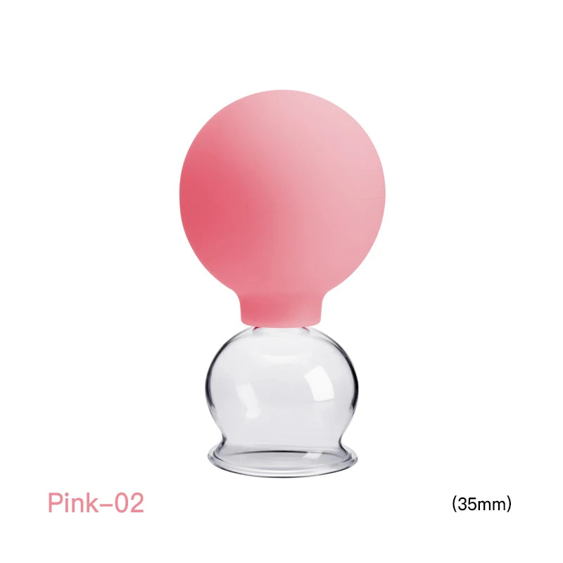 Pink silicone suction bulb on a clear glass 35mm cupping therapy jar against a white background.