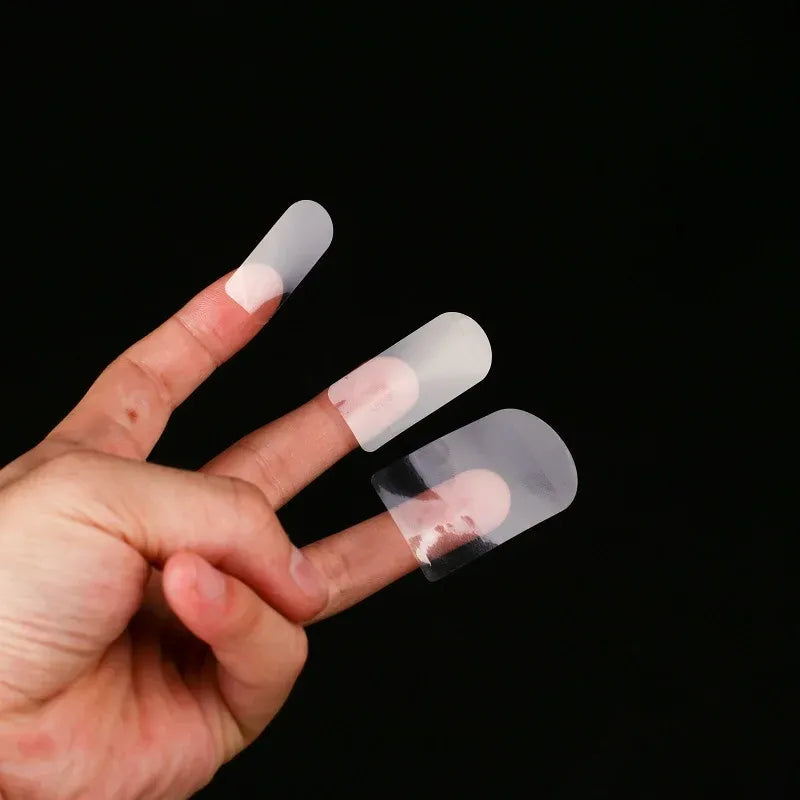 Clear round vinyl label stickers held in hand, see-through circular shape