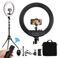 Black 18-inch LED ring light on tripod stand with smartphone holder, remote control, and carrying bag for photography.