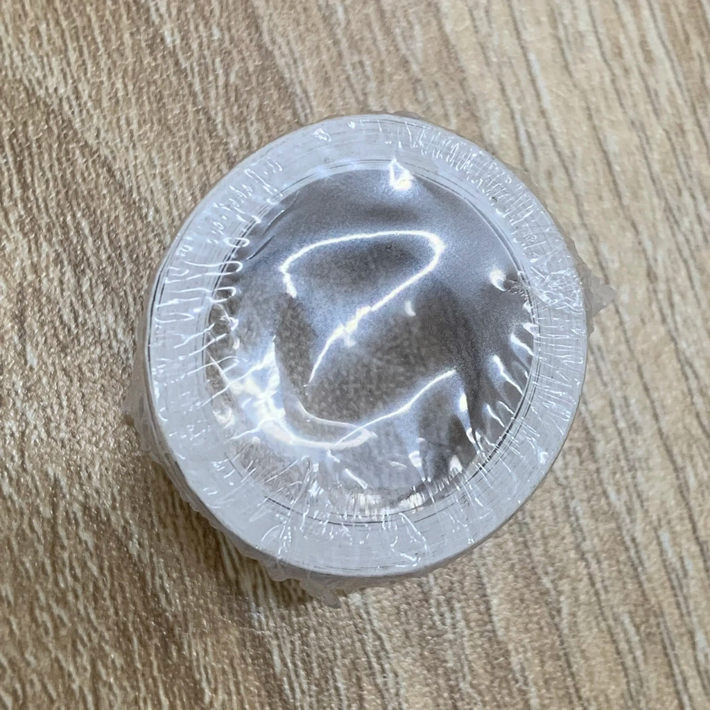 Round self-adhesive stamp roll shown under clear protective film