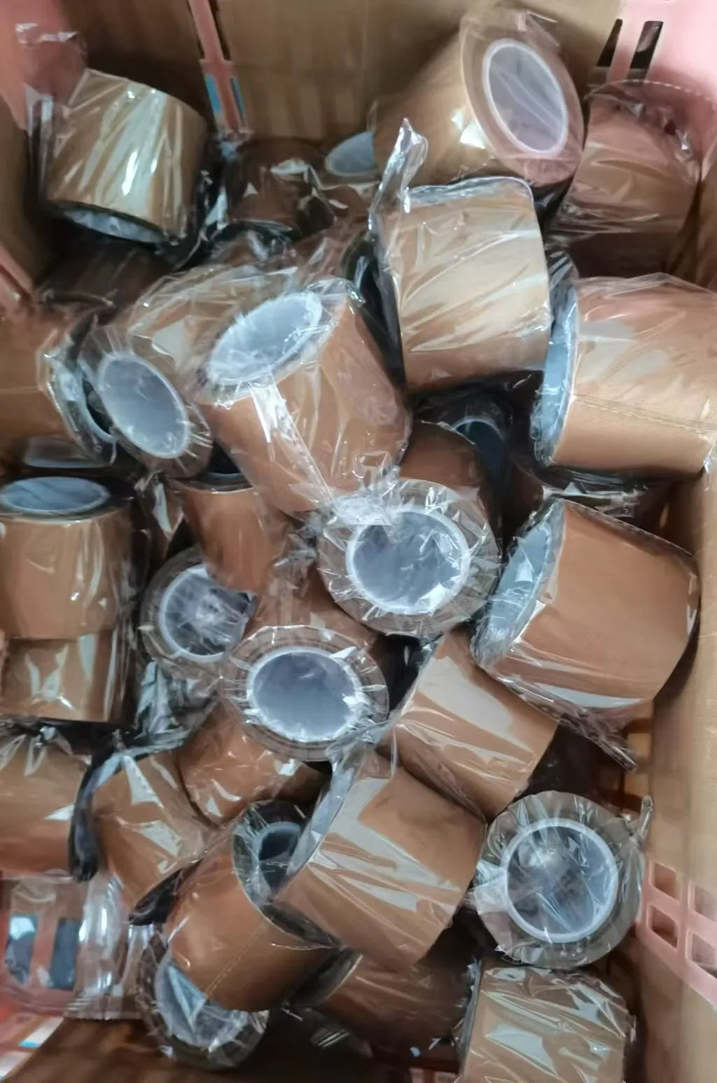 Brown tape rolls bundled and wrapped in clear plastic