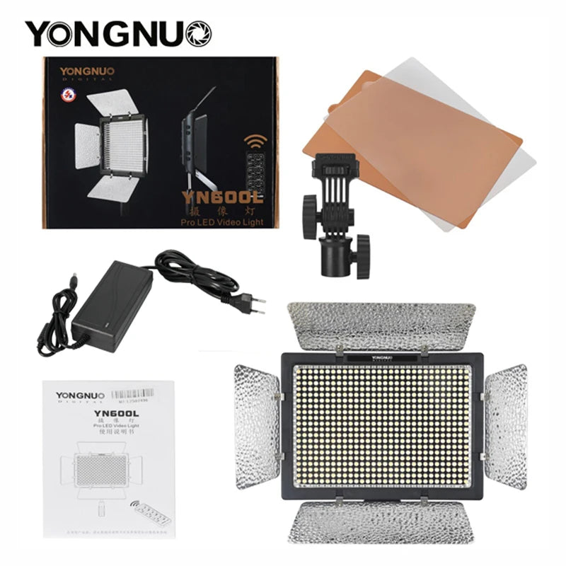 YN600L LED video light panel with barn doors, power adapter, mounting bracket, color filters, and user manual.