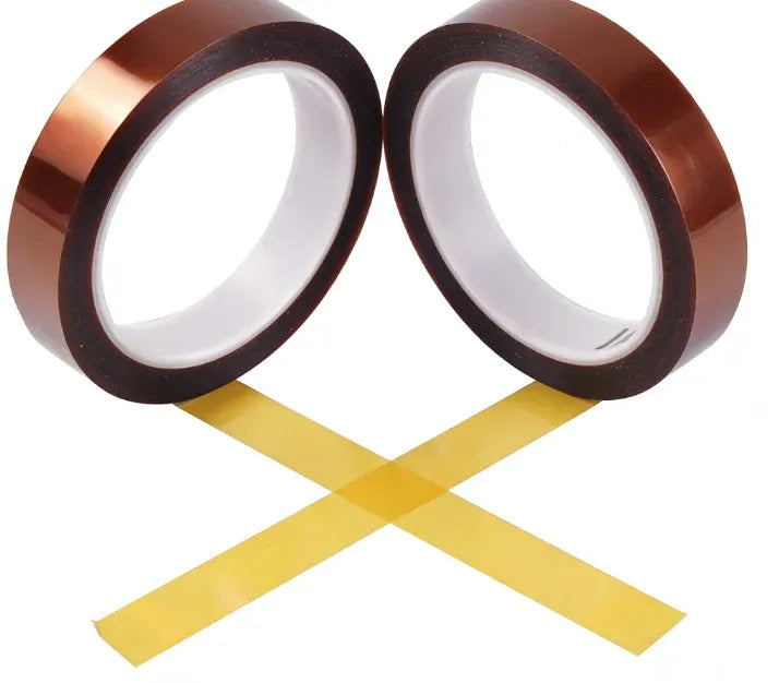 Two round rolls of brown polyimide tape with crosswise yellow die-cut pieces