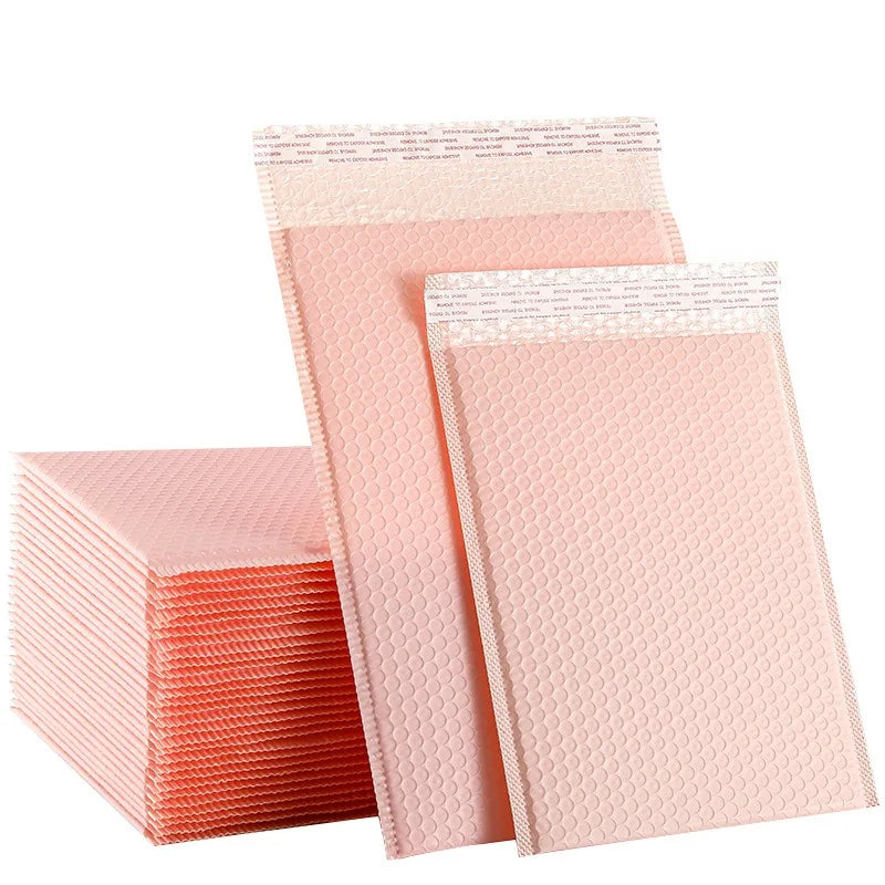 Waterproof pink bubble mailer envelope stack with self-seal strip and textured bubble surface