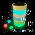 Glow-in-the-dark luminous tape rolls stacked, showing bright green and blue bands