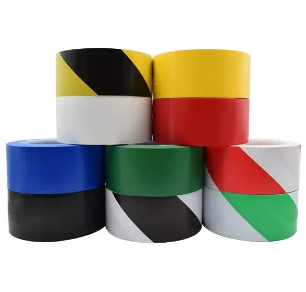 Water-activated PVC striped warning tape rolls, mixed colors on stacked cores.