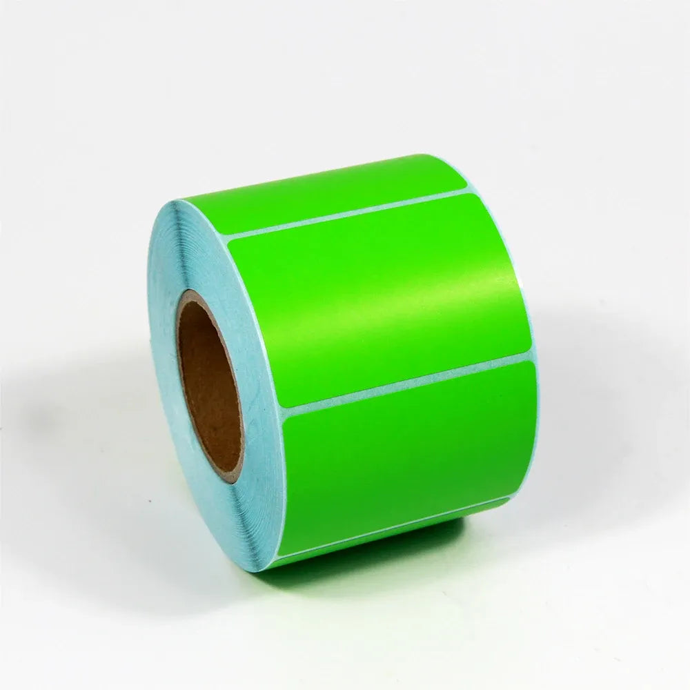 Green thermal label paper roll with rectangular label outlines on the tape.