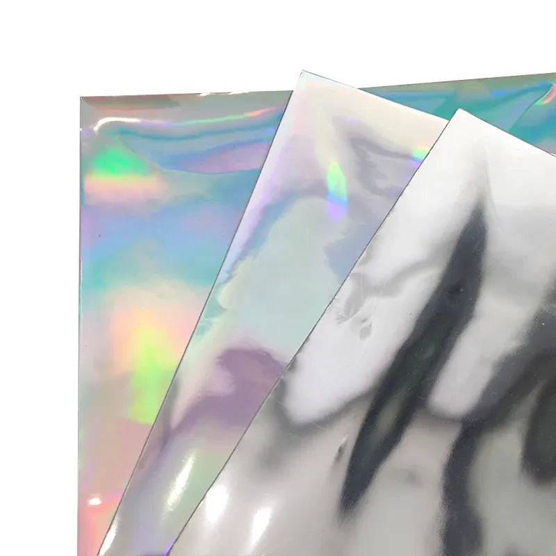Iridescent holographic film sheets with pastel rainbow highlights over silver backing