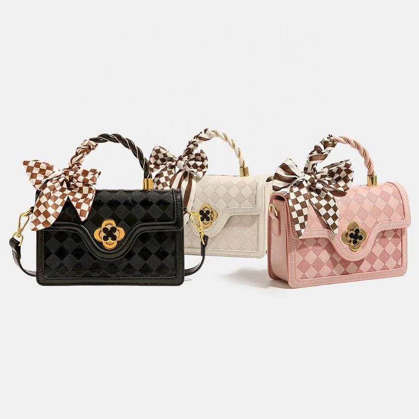 Black, white, and pink plaid leather trunk handbags with scarf ribbons, gold hardware, and quilted design for ladies.