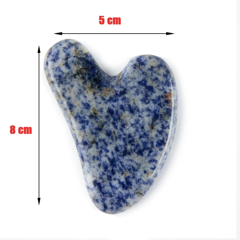 Heart-shaped blue and white mottled stone gua sha tool, 5 cm by 8 cm, isolated on a white background.