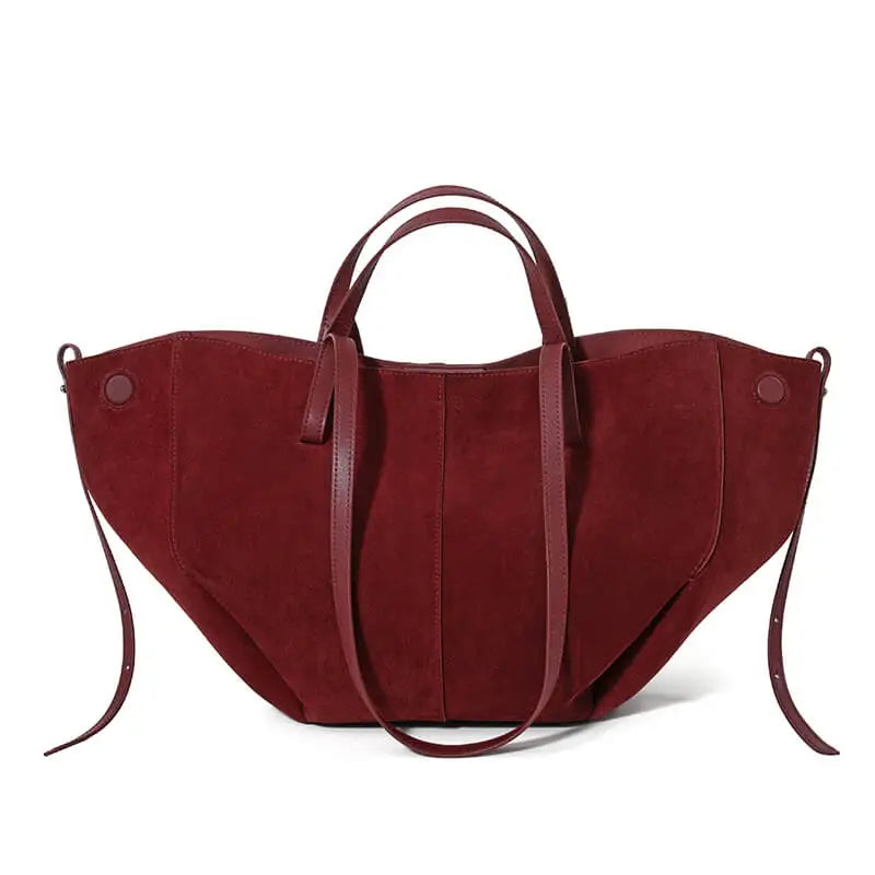 Burgundy suede leather designer tote bag with dual shoulder straps and winged silhouette. Large capacity luxury handbag.