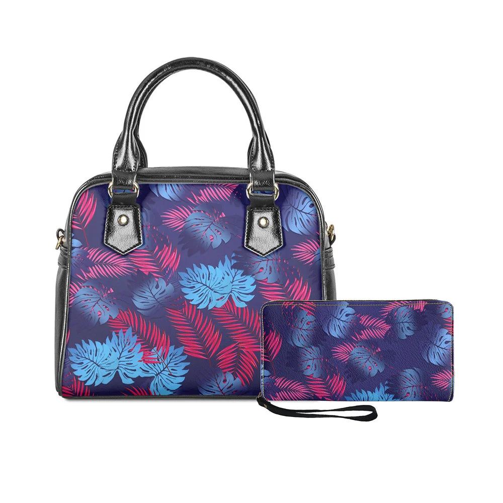 2-piece handbag and wallet set in black featuring a vibrant blue and pink Polynesian tropical monstera leaf print.
