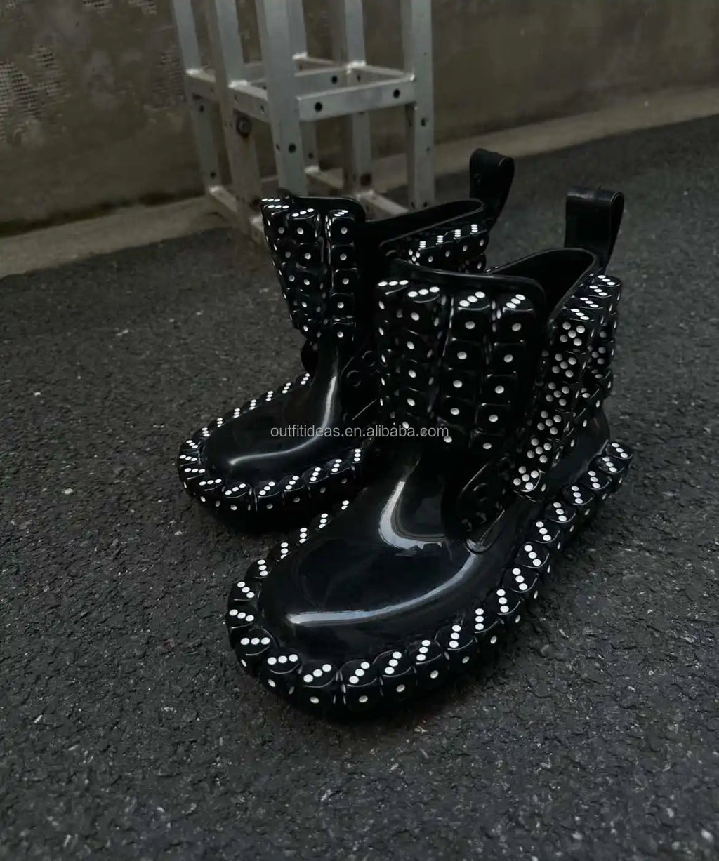 Black luxury ankle boots featuring dice embellishments, patent finish, and chunky lug sole. Unique designer footwear.