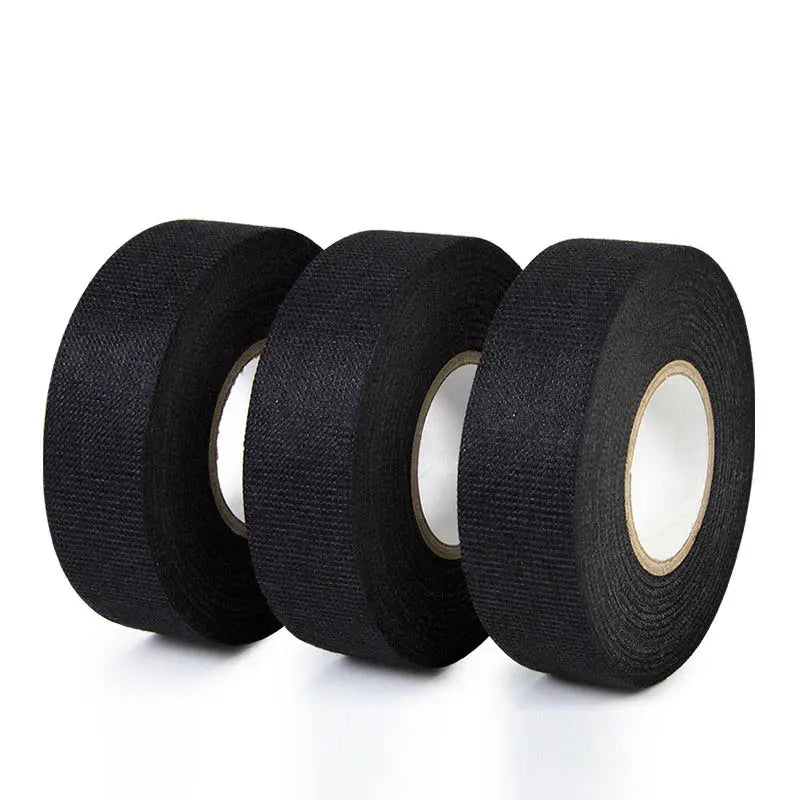 Stack of black fabric insulation tape rolls showing multiple roll faces and cores