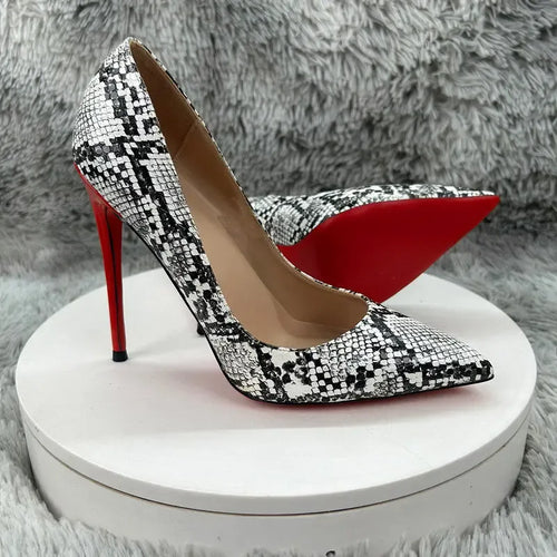 Luxury black and white snakeskin stiletto pumps with red soles, perfect for evening wear or formal occasions.
